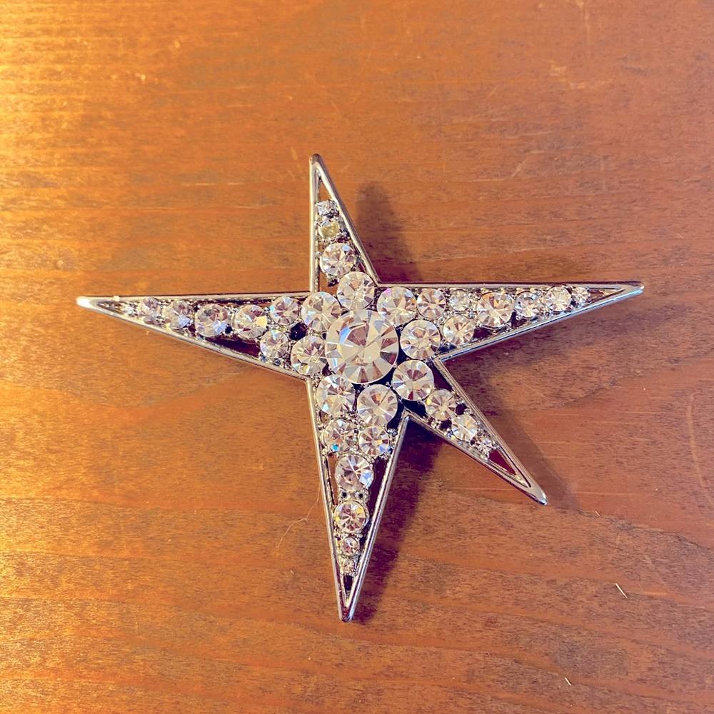 Vintage “Star” pin with clear  crystals & large round crystal in center.